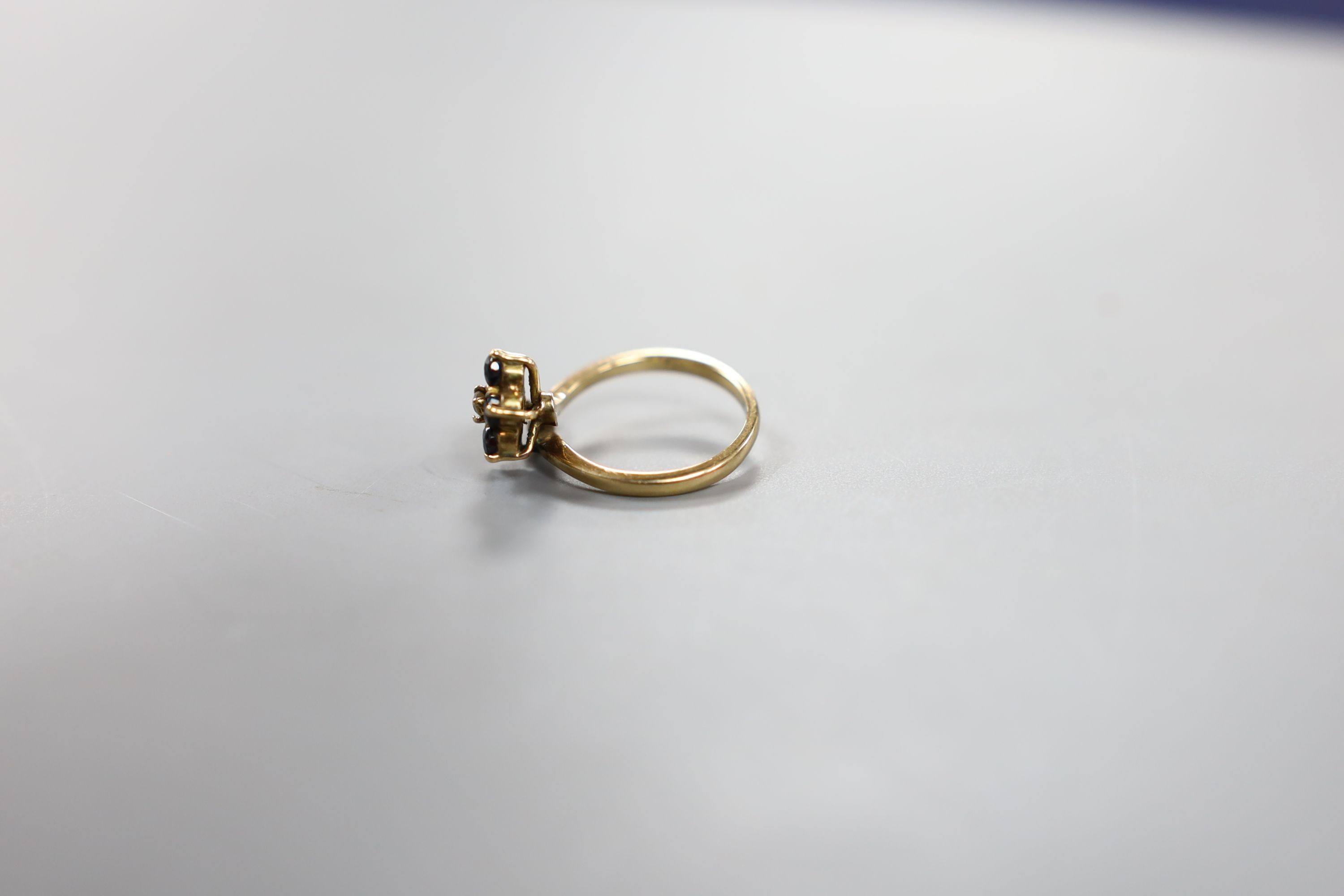 A 585 yellow metal, sapphire and diamond set dress ring, size G, gross weight 2.9 grams.